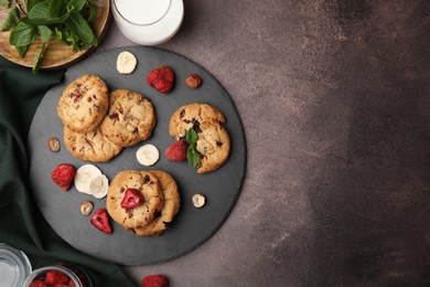 Photo of Cookies with freeze dried fruits, mint and nuts on grey table, flat lay. Space for text