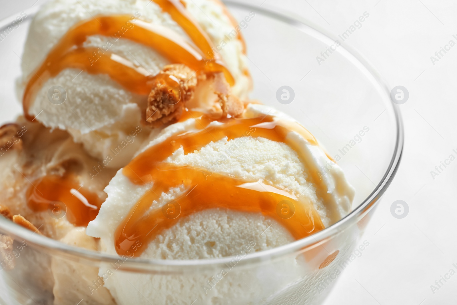 Photo of Bowl with caramel ice cream, closeup