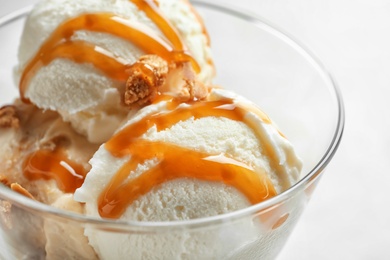 Photo of Bowl with caramel ice cream, closeup