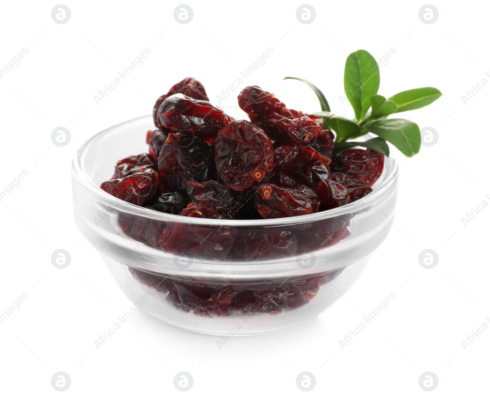 Photo of Tasty dried cranberries and leaves in bowl isolated on white