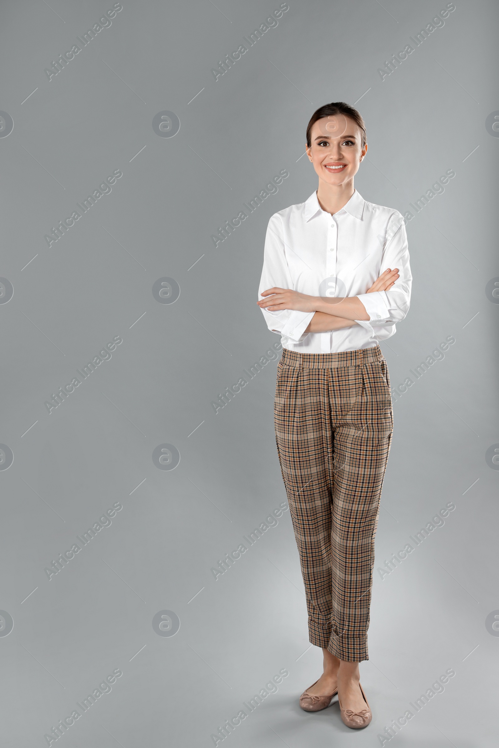 Photo of Full length portrait of young female teacher on grey background