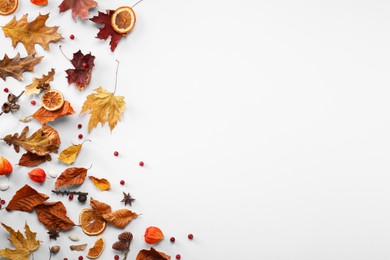 Photo of Flat lay composition with dry autumn leaves on white background. Space for text