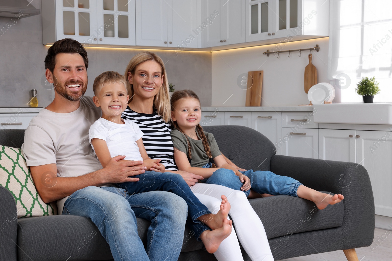 Photo of Portrait of happy family with children on sofa at home