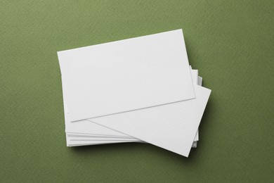 Photo of Blank business cards on khaki background, top view. Mockup for design
