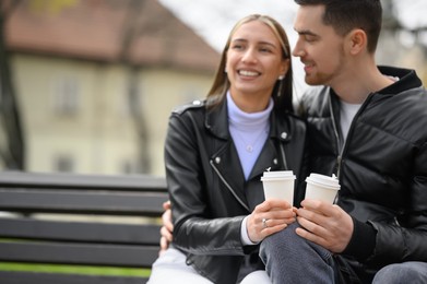 Photo of Lovely young couple spending time together outdoors, focus on hands. Romantic date