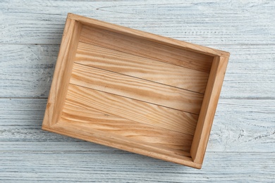 Empty crate on wooden background, top view