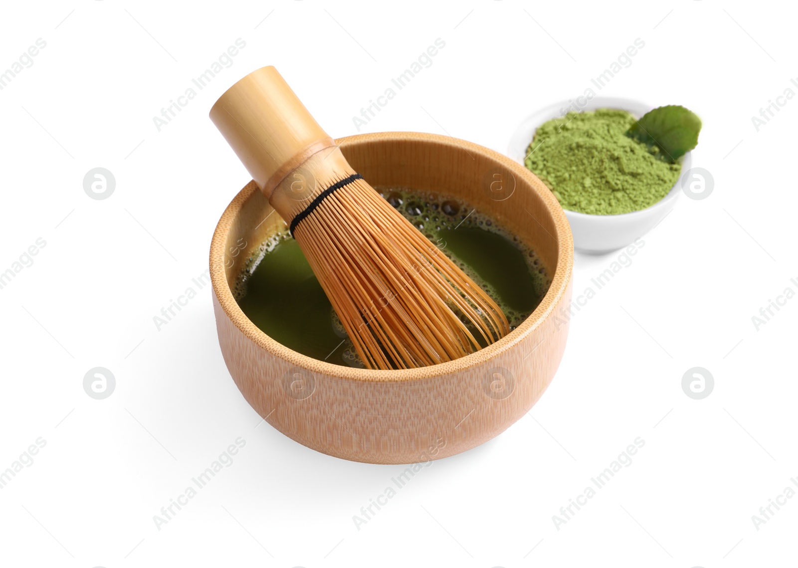 Photo of Bowl of fresh matcha tea with bamboo whisk and powder isolated on white