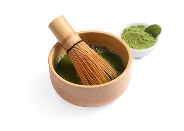 Bowl of fresh matcha tea with bamboo whisk and powder isolated on white