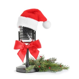 Photo of Retro microphone with Santa hat isolated on white. Christmas music concept