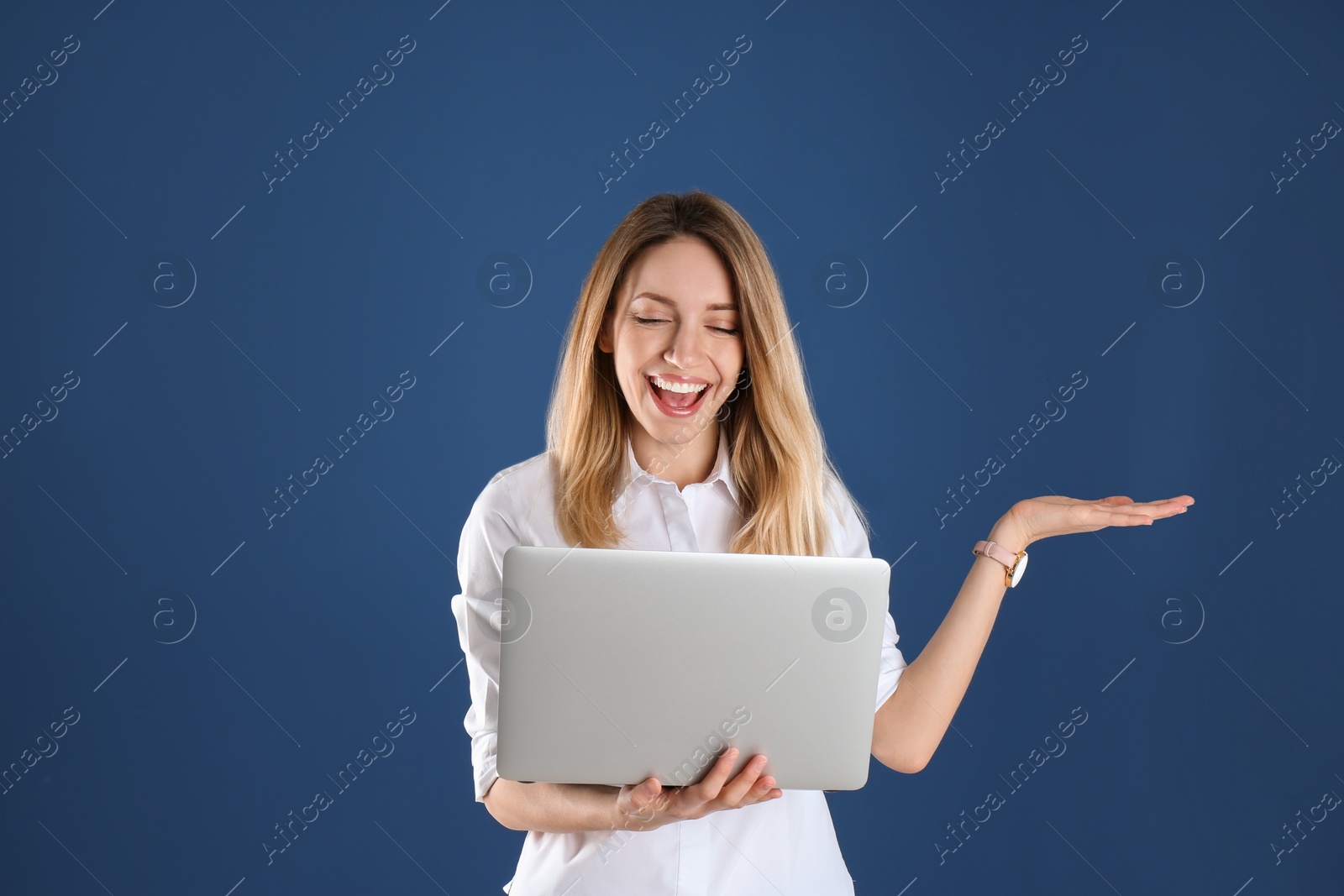 Photo of Portrait of young woman in office wear with laptop on color background