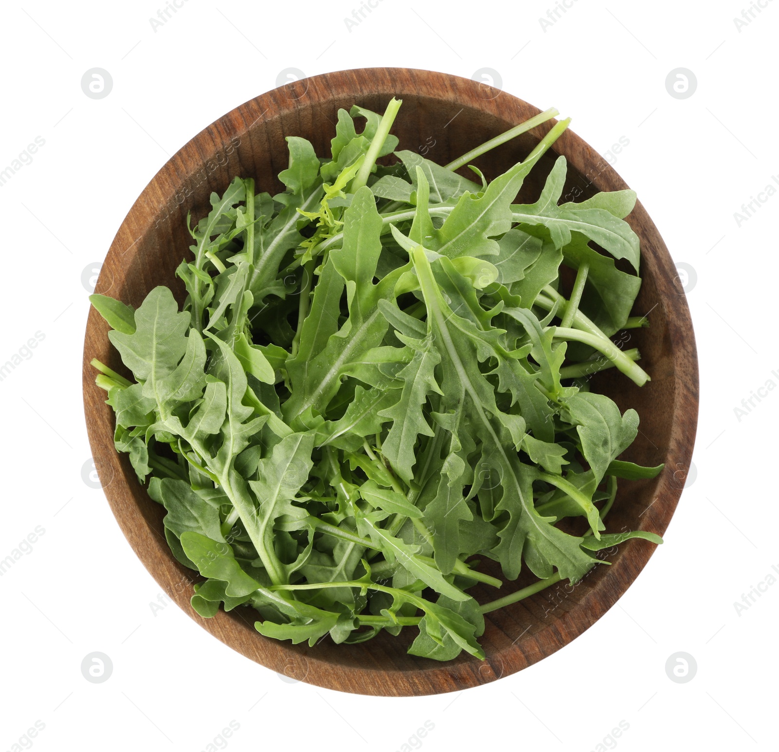 Photo of Delicious fresh arugula in wooden bowl isolated on white, top view