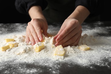 Woman making shortcrust pastry at table, closeup