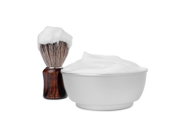 Photo of Shaving brush and bowl of foam on white background