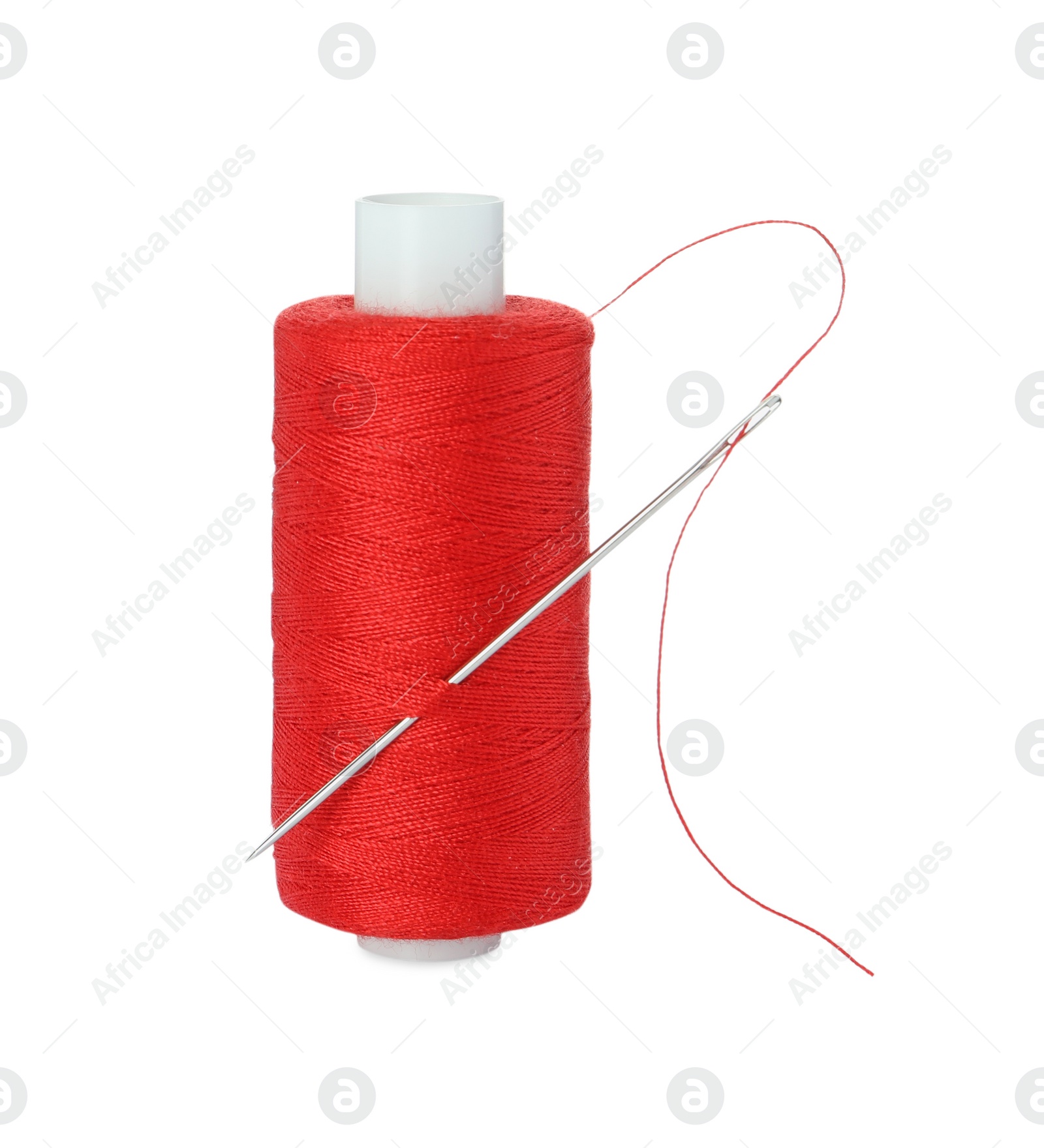 Photo of Spool of red sewing thread with needle isolated on white