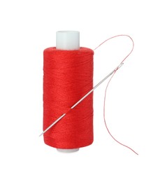 Photo of Spool of red sewing thread with needle isolated on white