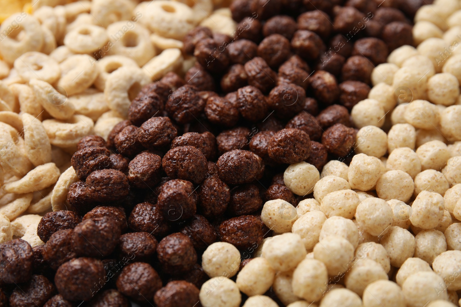 Photo of Different types of breakfast cereals as background, closeup