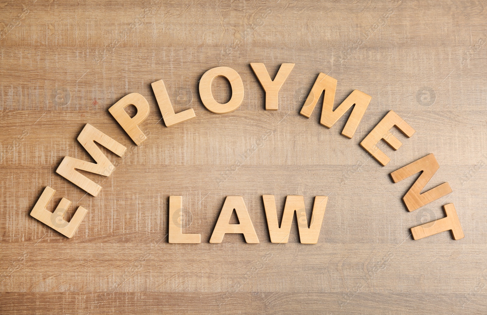 Photo of Flat lay composition with words EMPLOYMENT LAW on wooden background