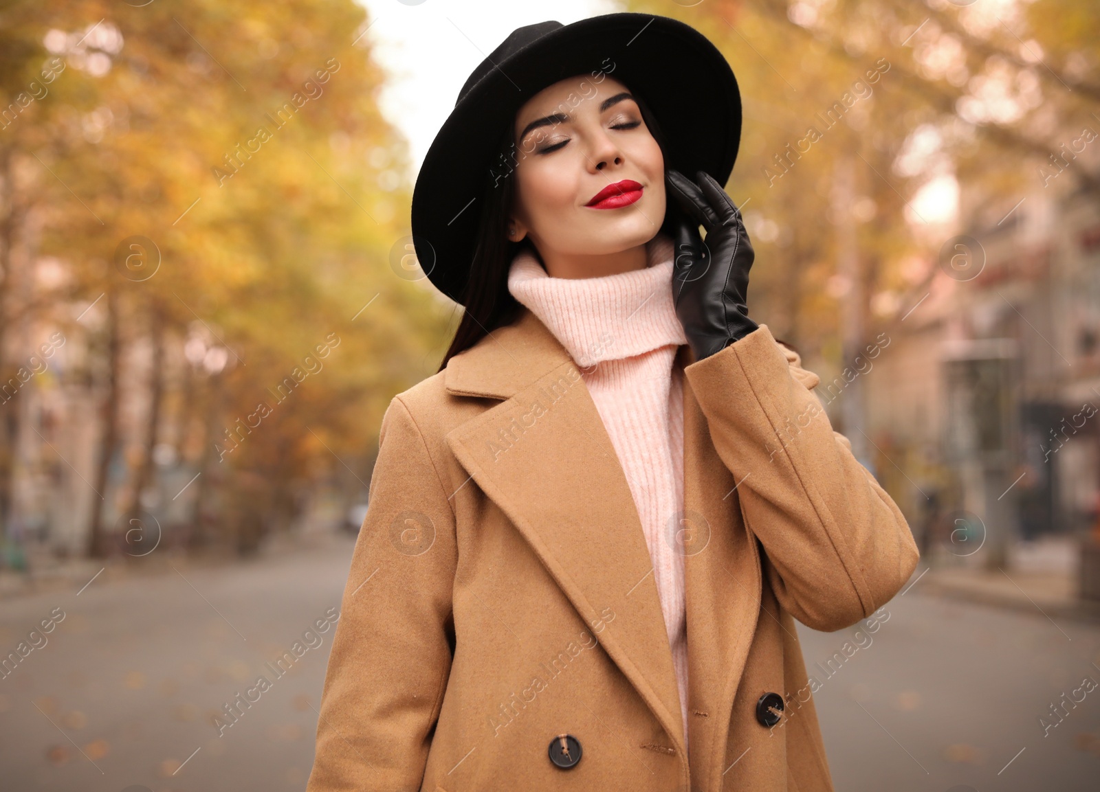 Photo of Young woman wearing stylish clothes on city street, space for text. Autumn look