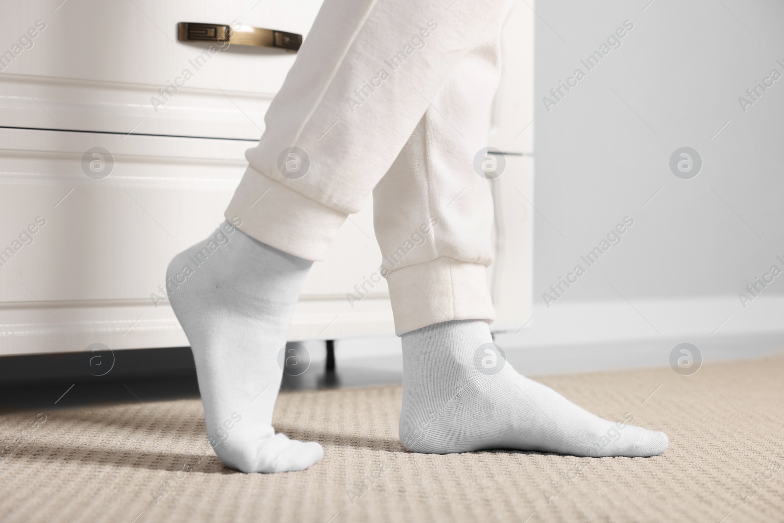 Photo of Woman in stylish white socks indoors, closeup