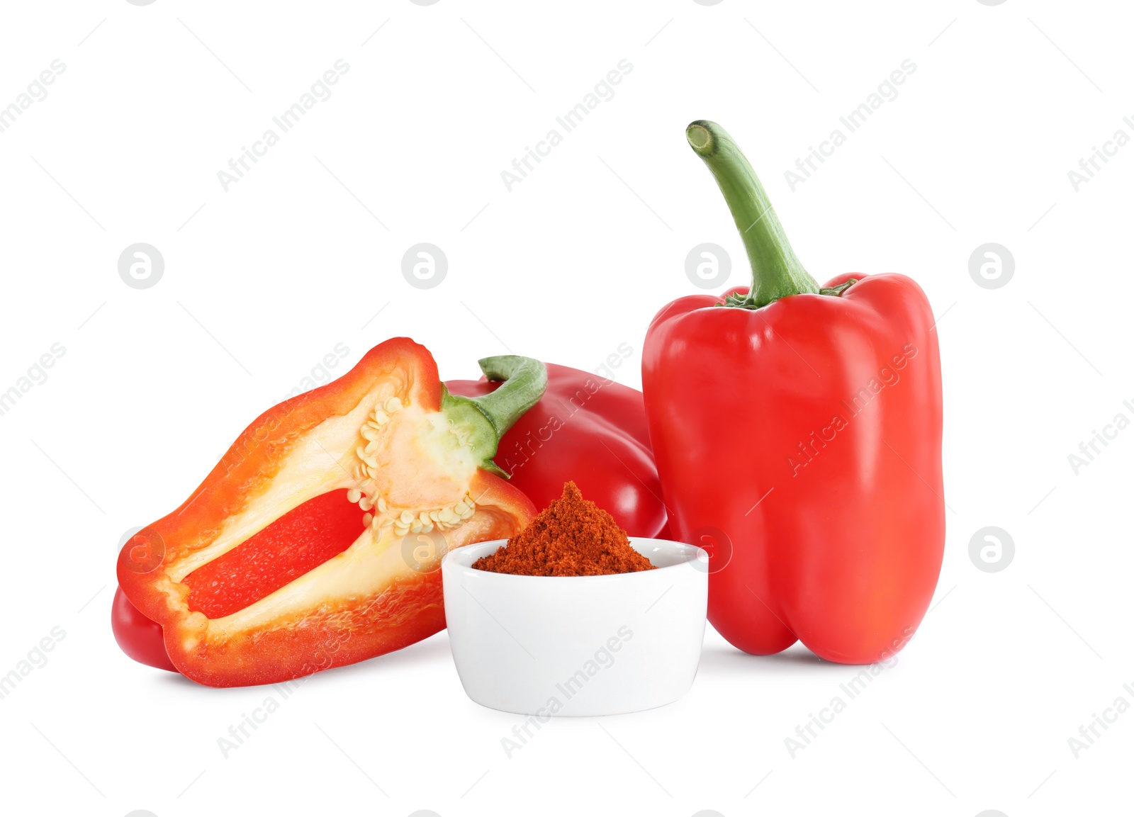 Photo of Fresh bell peppers and bowl of paprika powder on white background