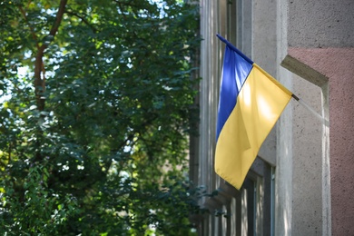 Photo of National flag of Ukraine on building wall outdoors