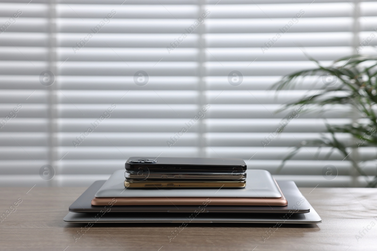 Photo of Many different modern gadgets on wooden table indoors. Space for text