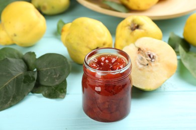 Photo of Delicious quince jam on light blue wooden table, closeup