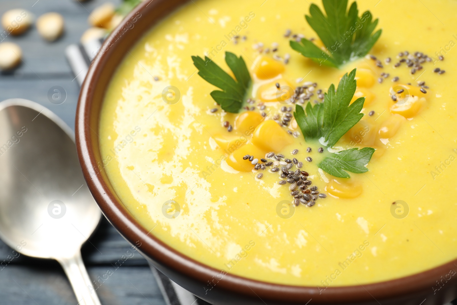 Photo of Delicious creamy corn soup on table, closeup