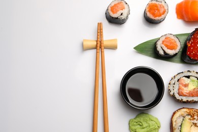 Photo of Set of delicious sushi rolls on white background, flat lay. Space for text