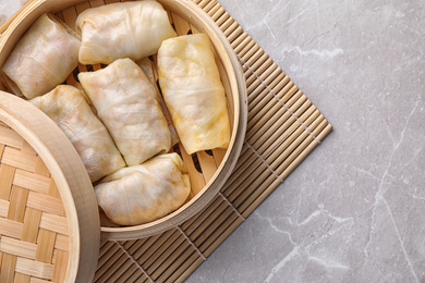 Photo of Delicious cabbage rolls served on light grey marble table, top view