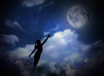 Image of Sleepwalking condition. Silhouette of girl reaching to moon on starry night