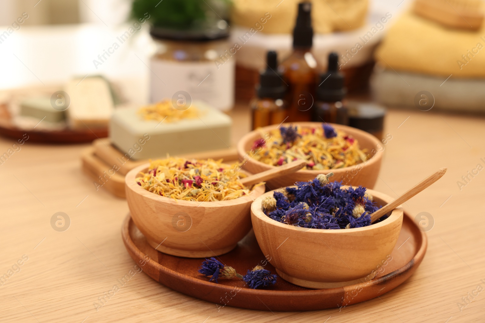 Photo of Dry flowers on wooden table, closeup and space for text. Spa time