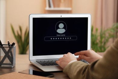 Woman unlocking laptop with blocked screen indoors, closeup