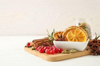 Photo of Composition with mulled wine ingredients on white wooden table. Space for text
