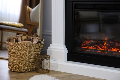 Photo of Modern fireplace in room, closeup. Interior design