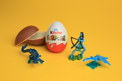 Photo of Sveti Vlas, Bulgaria - July 3, 2023: Kinder Surprise Eggs and toys on yellow background
