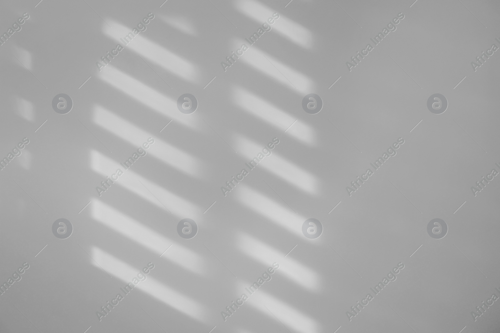 Image of Light and shadows falling on white wall