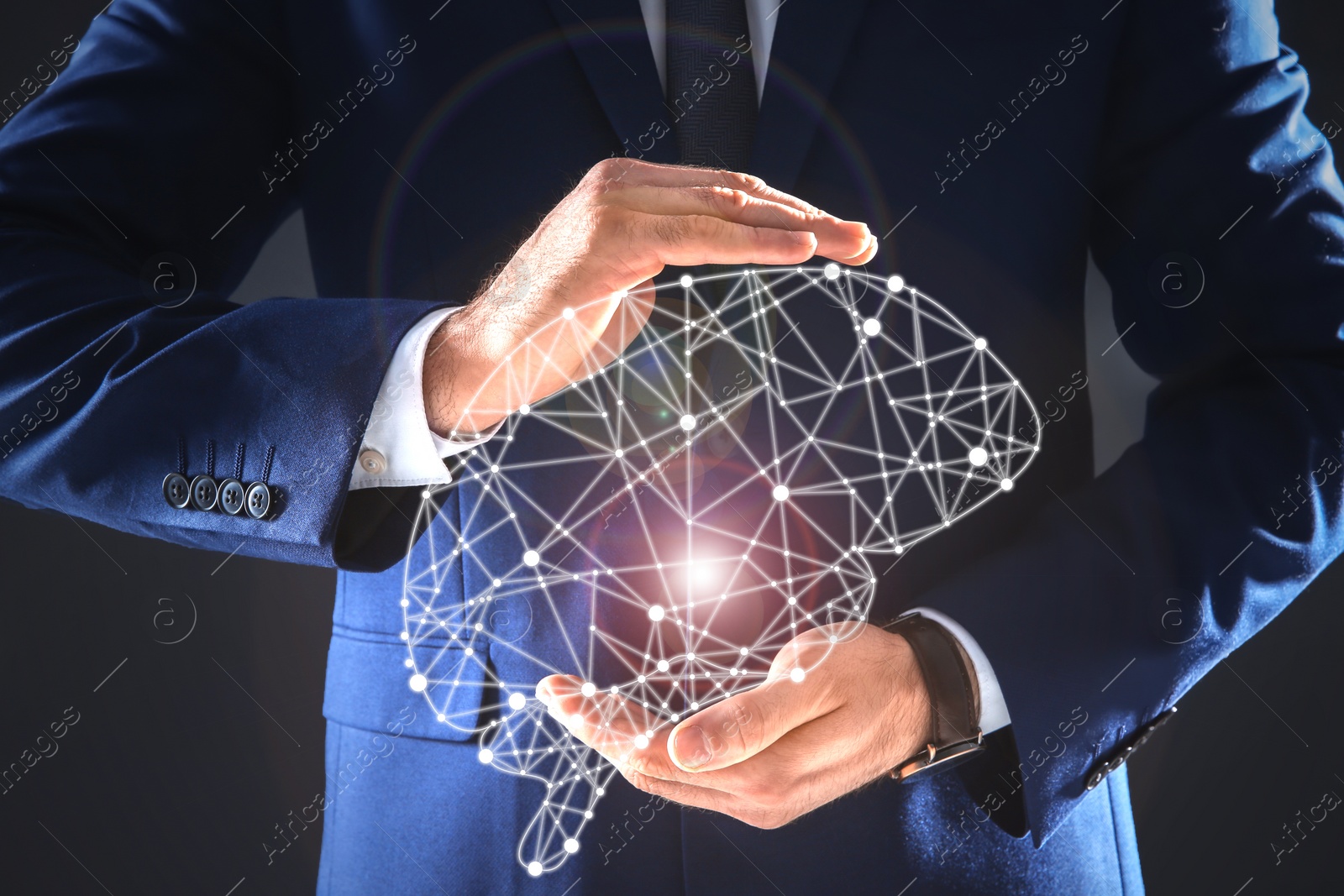 Image of Businessman holding digital image of brain in hands on dark background, closeup. Machine learning concept 