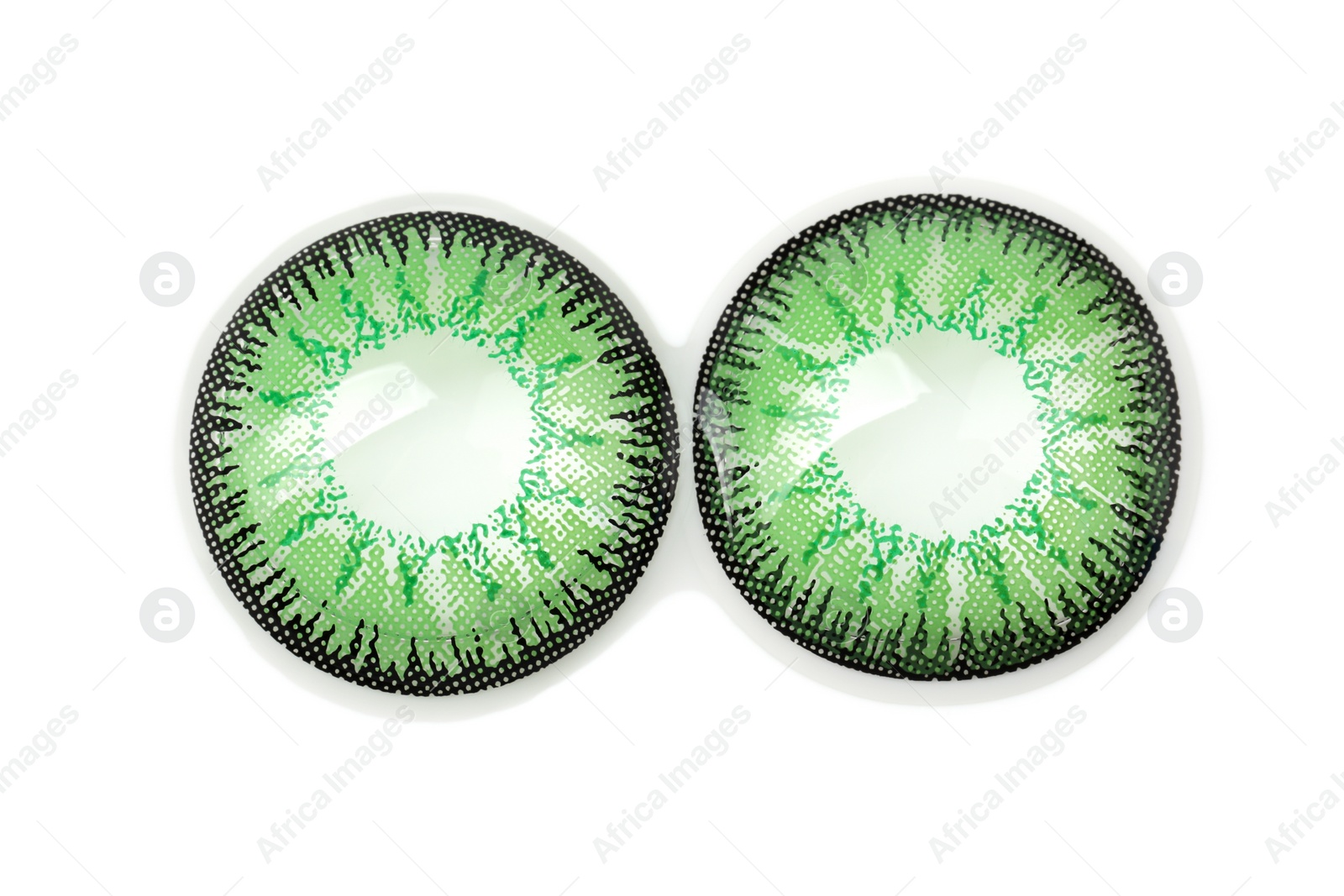 Photo of Two green contact lenses isolated on white, top view