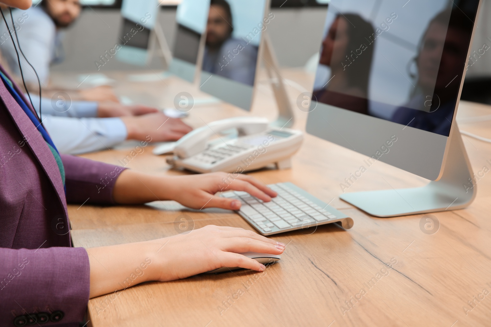 Photo of Technical support operator working with computer at table in office, closeup