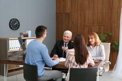 Photo of Lawyers having meeting with young couple in office