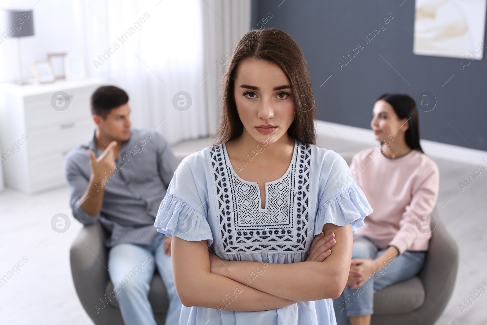 Photo of Unhappy woman feeling jealous while couple spending time together at home