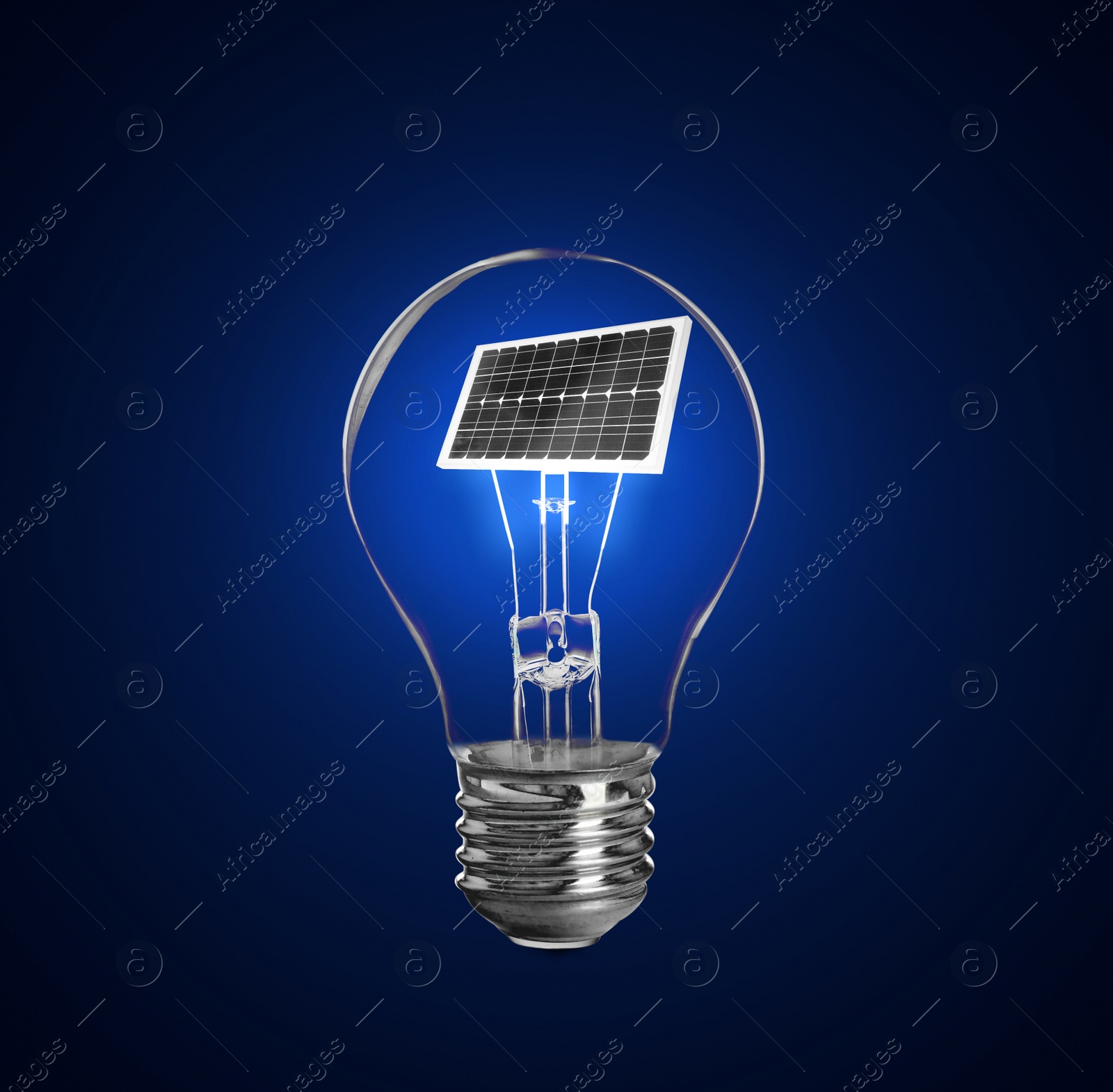 Image of Alternative energy source. Light bulb with solar panel on blue background 