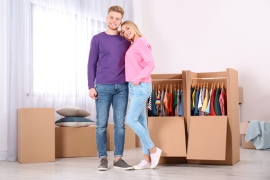 Photo of Young couple near wardrobe boxes at home