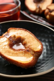 Tasty baked quince with honey in bowl on table, closeup