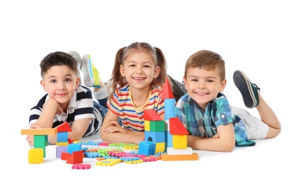 Photo of Little children playing together on white background. Indoor entertainment