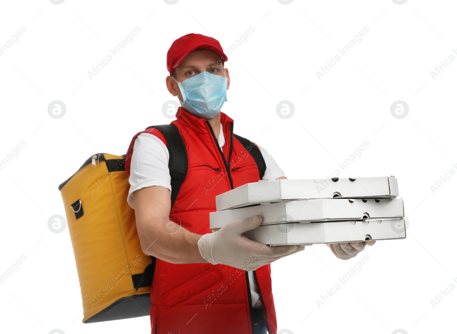 Photo of Courier in protective mask and gloves holding pizza boxes on white background. Food delivery service during coronavirus quarantine