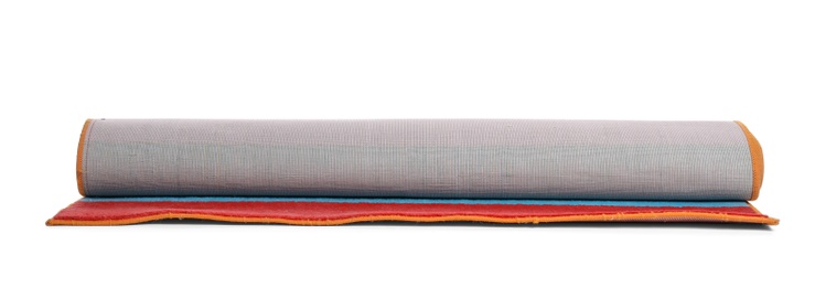 Photo of Rolled colorful carpet on white background. Interior element