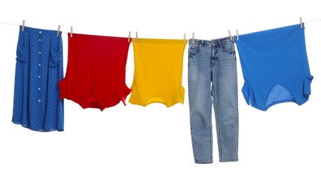 Different clothes drying on laundry line against white background