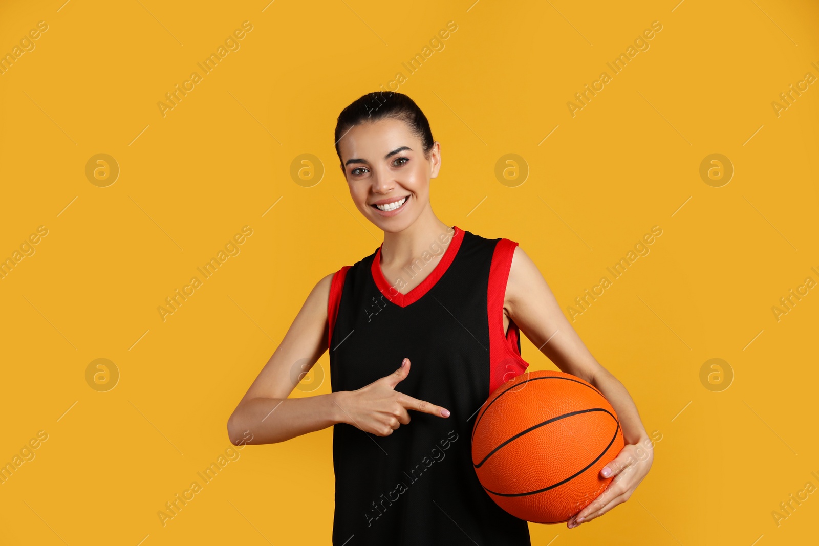 Photo of Basketball player with ball on yellow background